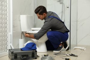 A professional demonstrates how to stop a running toilet