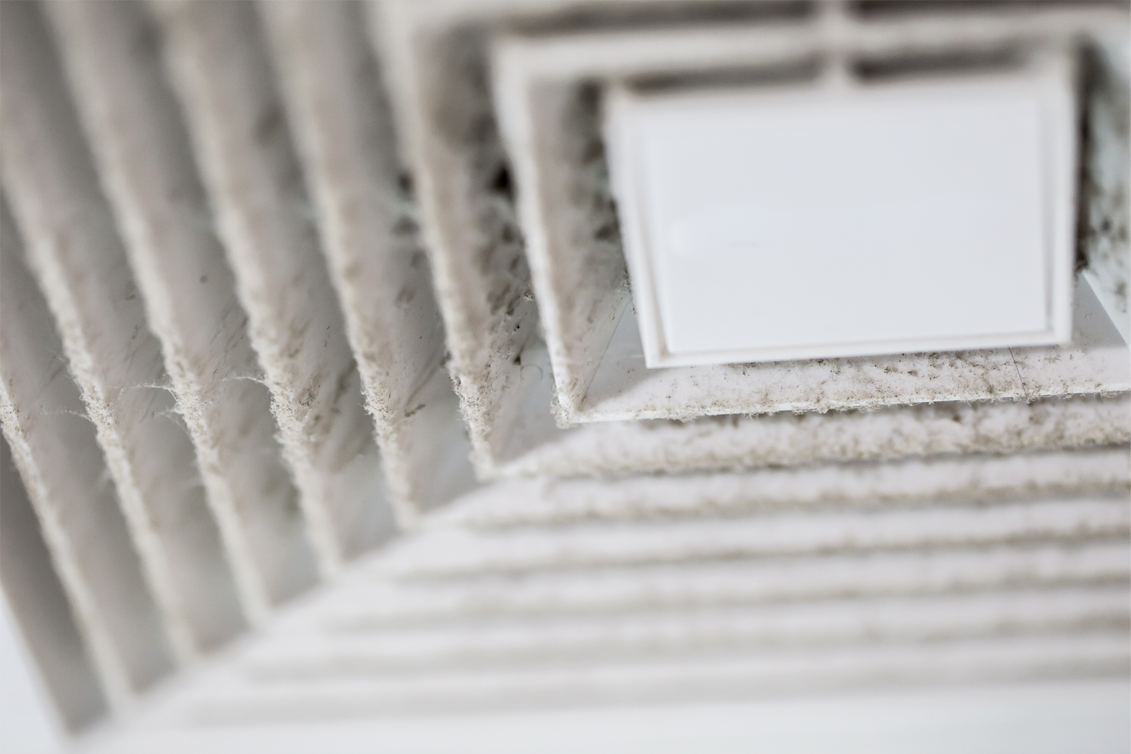 an air duct covered in dust requires professional duct cleaning